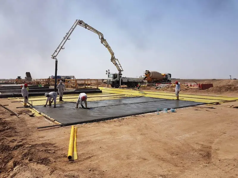 Site crew preparing a large concrete slab area