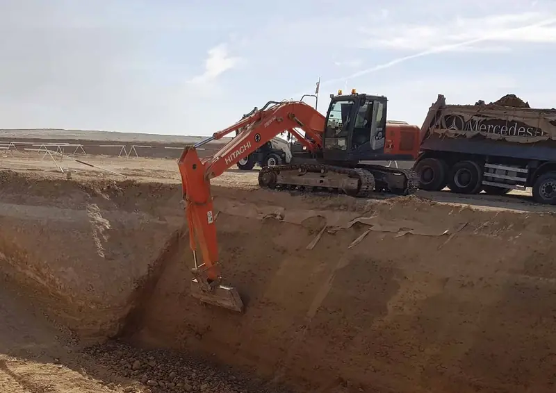 Excavator loading a tipper truck during earthworks